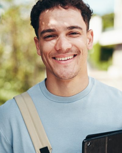 Portrait, happy student and man at park with tablet for learning, education or scholarship at college outdoor. Smile, face and confident person at university campus for studying or travel to Portugal.